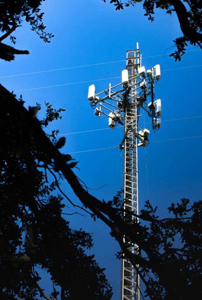 Cell tower with antennas against a blue sky