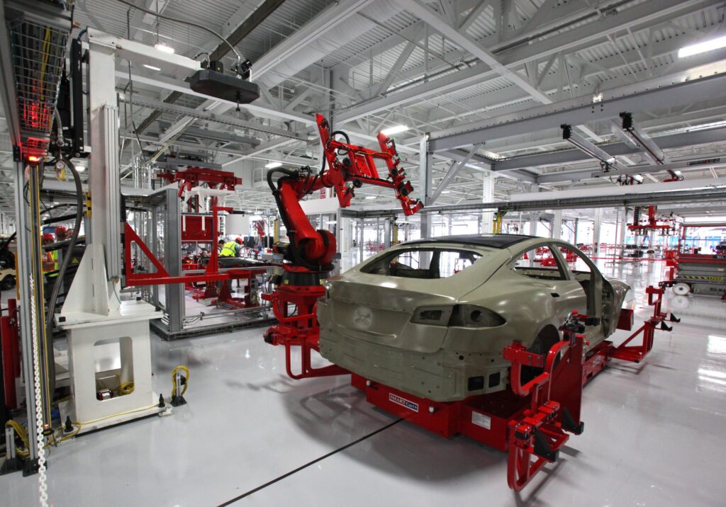 Modern robotic car assembly line representing manufacturing activity